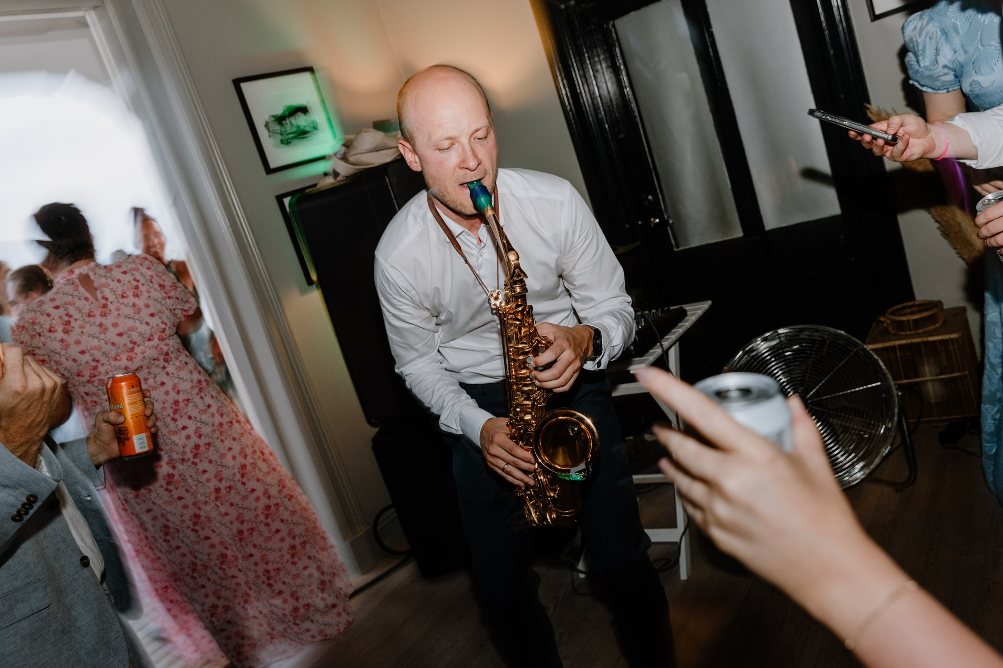 Andreas playing saxophone at a party